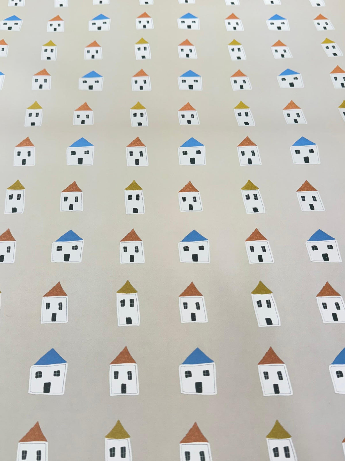 Tan house-patterned gift wrap sheet with minimal beige design on white background
