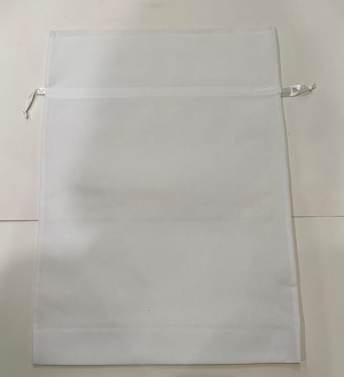 Double edge cotton gift bag with drawstring closure in natural fabric