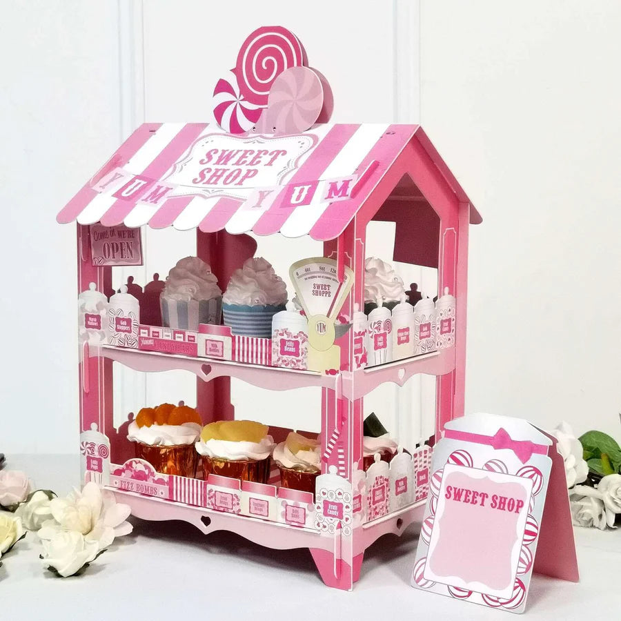Tiered cardboard cupcake stand displaying six frosted cupcakes with colorful toppings