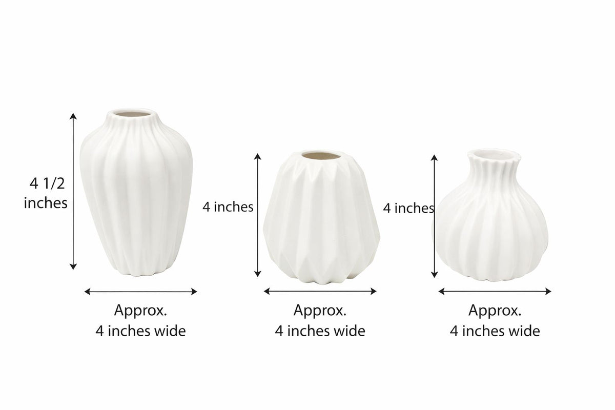 Three white porcelain ribbed vases in graduated sizes arranged together