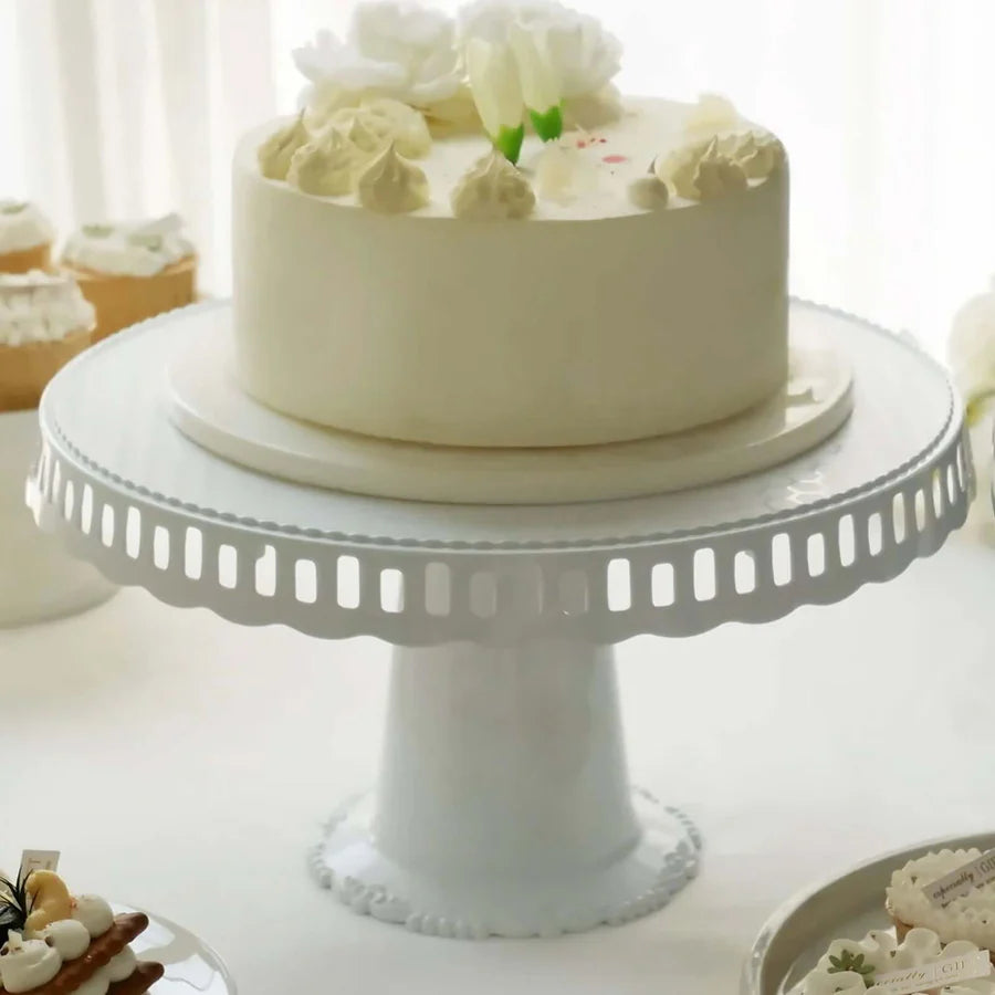 4-tier clear plastic round pedestal cake stand with white base displayed empty
