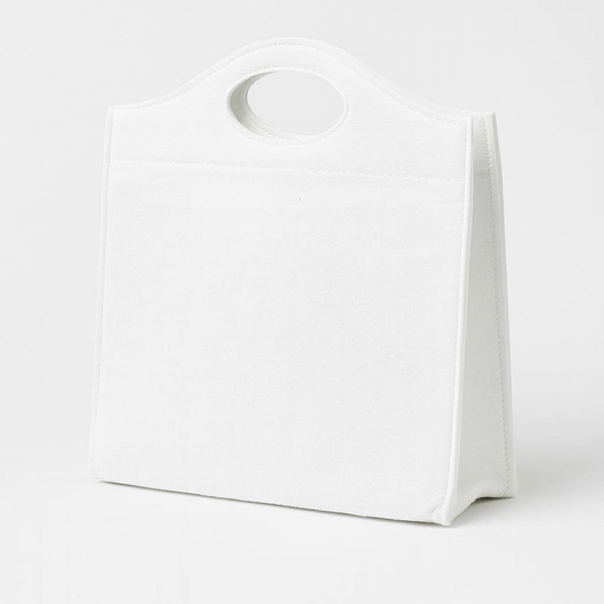 Colorful die-cut felt bag with decorative cutout patterns and handles for storage