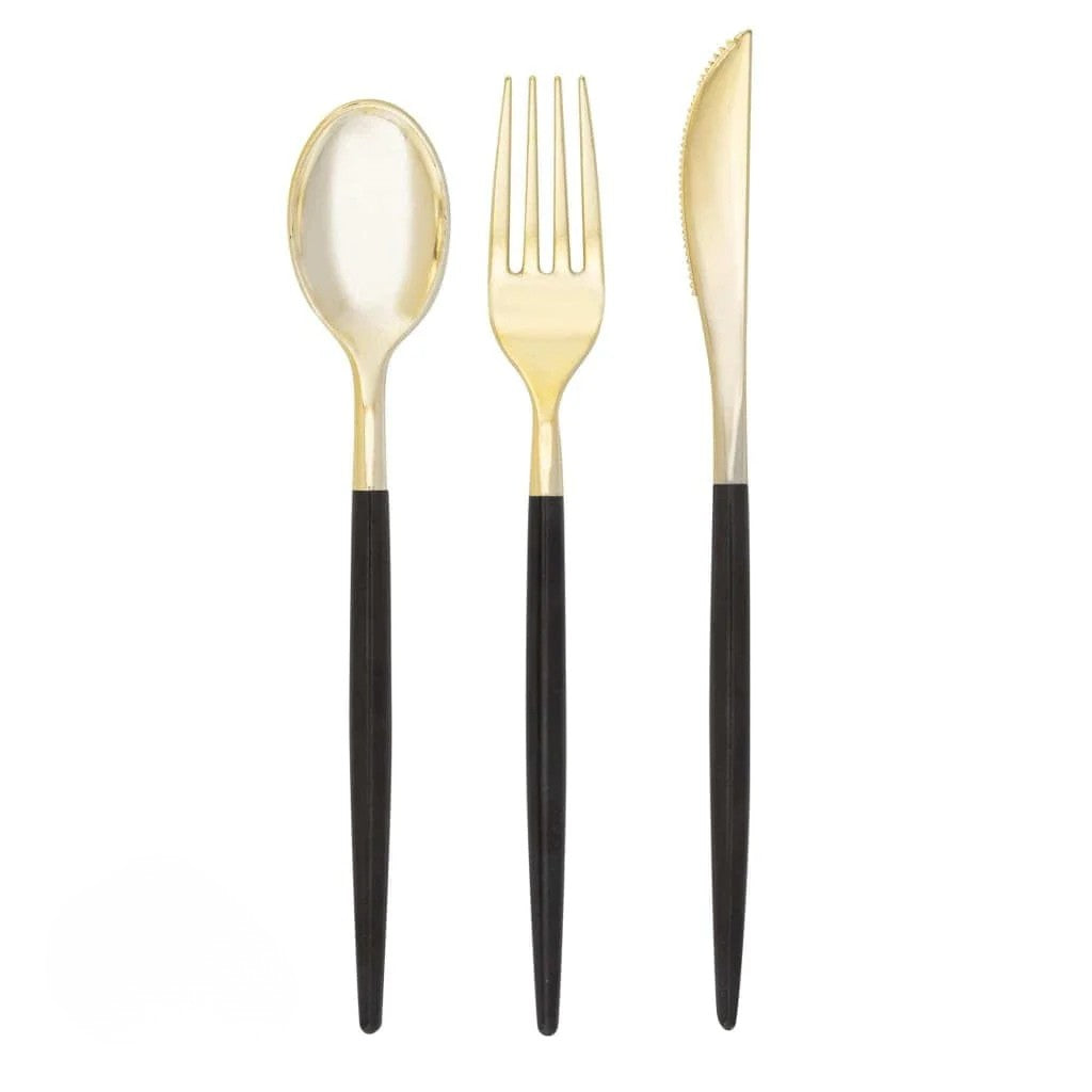 Gold spoon, fork, and knife with black handles on a white background