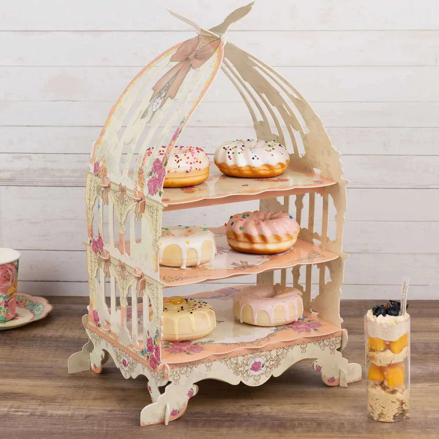 Tiered cardboard cupcake stand displaying multiple cupcakes with decorative frosting