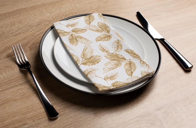 Gilded leaves paper napkin with gold foil botanical design on white background
