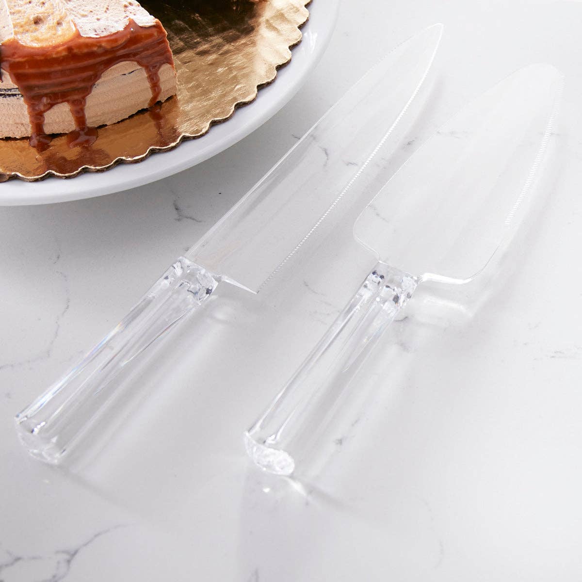 Stainless steel cake knife and server pair with elegant handles, displayed together